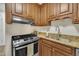 Kitchen with granite countertops, wooden cabinets, stainless steel appliances at 608 Cross Timbers Dr, Durham, NC 27713