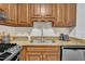 Close up of kitchen appliances, stainless steel sink, granite countertops and wooden cabinets at 608 Cross Timbers Dr, Durham, NC 27713