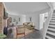 Open living room featuring a brick fireplace, modern decor, and staircase to the second floor at 608 Cross Timbers Dr, Durham, NC 27713