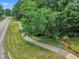 Scenic street view highlighting the sidewalk and road with greenery surroundings and street signage at 608 Cross Timbers Dr, Durham, NC 27713