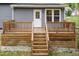 Backyard view featuring a wooden deck with steps leading down to the grass at 612 Dunbar St, Durham, NC 27701
