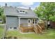 Backyard view featuring a wooden deck, lush green lawn, and charming exterior at 612 Dunbar St, Durham, NC 27701