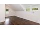 Bright bedroom featuring hardwood floors, two windows, and crisp, white trim at 612 Dunbar St, Durham, NC 27701