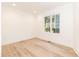 Bedroom with laminate flooring, neutral color palette, and window with backyard view at 612 Dunbar St, Durham, NC 27701