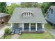 Charming home with a covered front porch, mature trees, and classic architectural details at 612 Dunbar St, Durham, NC 27701