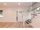 Bright foyer featuring new laminate flooring, and a staircase with iron railings at 612 Dunbar St, Durham, NC 27701