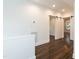 Upstairs hallway with dark laminate flooring, light gray paint, and barn doors at 612 Dunbar St, Durham, NC 27701
