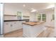 Bright kitchen with white cabinets, wood island, stainless steel appliances, and natural light at 612 Dunbar St, Durham, NC 27701