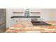 Close up of kitchen featuring wood island, stainless steel appliances, and matte black hardware at 612 Dunbar St, Durham, NC 27701
