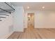 Open-concept living area with light laminate floors and a minimalist staircase at 612 Dunbar St, Durham, NC 27701