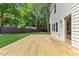 Wooden deck in the backyard of the home leads to a sliding glass door at 6709 Sunhaven Pl, Raleigh, NC 27615
