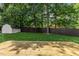 A wooden deck over looks a large yard with tall trees and a storage shed at 6709 Sunhaven Pl, Raleigh, NC 27615