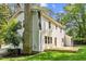 Beautifully landscaped backyard with a brick chimney, a deck, and lush green grass at 6709 Sunhaven Pl, Raleigh, NC 27615
