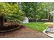 Green backyard featuring lush landscaping, a shed, and wooded fencing for privacy at 6709 Sunhaven Pl, Raleigh, NC 27615