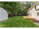 Well-maintained backyard featuring a lush lawn, a wooden deck, a shed, and privacy fence at 6709 Sunhaven Pl, Raleigh, NC 27615