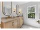 This primary bathroom has double sinks, a marble countertop, and modern fixtures at 6709 Sunhaven Pl, Raleigh, NC 27615