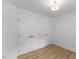 Bright bedroom with wood floors features a closet with double doors and an entry door at 6709 Sunhaven Pl, Raleigh, NC 27615