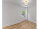 Bright, minimalist bedroom with wood flooring and single window offers natural light at 6709 Sunhaven Pl, Raleigh, NC 27615
