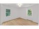 This bedroom with wood floors offers lots of natural light from its dual windows at 6709 Sunhaven Pl, Raleigh, NC 27615