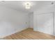 Bright bedroom with wood floors features a closet with double doors and an entry door at 6709 Sunhaven Pl, Raleigh, NC 27615