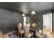 Dining room featuring dark walls, a wood table with seating, and a modern chandelier at 6709 Sunhaven Pl, Raleigh, NC 27615