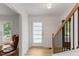 Bright foyer featuring a modern door, hardwood floors, and a staircase at 6709 Sunhaven Pl, Raleigh, NC 27615