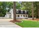 Charming two-story home with black roof, dormers, and a well-manicured lawn at 6709 Sunhaven Pl, Raleigh, NC 27615