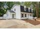 Charming two-story home with black roof, dormers, and a well-manicured lawn at 6709 Sunhaven Pl, Raleigh, NC 27615