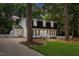 Charming two-story home with black roof, dormers, and a well-manicured lawn at 6709 Sunhaven Pl, Raleigh, NC 27615