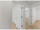 Bright hallway boasts white walls, doors and wood flooring with multiple entryways at 6709 Sunhaven Pl, Raleigh, NC 27615