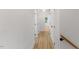 Hallway featuring a light-colored wood floor and all-white walls with doorways on either side at 6709 Sunhaven Pl, Raleigh, NC 27615