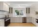 Modern kitchen featuring white cabinets, tile backsplash, and stainless steel appliances at 6709 Sunhaven Pl, Raleigh, NC 27615