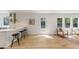 Open kitchen with white bar, modern stools, and a view of the cozy seating area at 6709 Sunhaven Pl, Raleigh, NC 27615