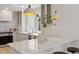 Modern kitchen with white cabinets, marble countertops, and stainless steel fixtures at 6709 Sunhaven Pl, Raleigh, NC 27615