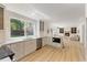 Open-concept kitchen featuring white cabinets, hardwood floors, and stainless steel appliances at 6709 Sunhaven Pl, Raleigh, NC 27615