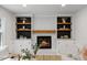 Living room with built-in shelving flanking a fireplace, creating a cozy focal point at 6709 Sunhaven Pl, Raleigh, NC 27615