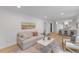 Spacious living room with hardwood floors and a kitchen view, perfect for entertaining at 6709 Sunhaven Pl, Raleigh, NC 27615