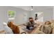 Bright living room with paneled walls, hardwood floors, and comfortable seating at 6709 Sunhaven Pl, Raleigh, NC 27615