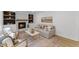 Cozy living room featuring a fireplace, built-in shelves, and comfortable seating at 6709 Sunhaven Pl, Raleigh, NC 27615