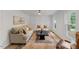 Bright living room with paneled walls, hardwood floors, and comfortable seating at 6709 Sunhaven Pl, Raleigh, NC 27615