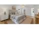 This bedroom features a decorative chandelier, accent rug, and a luxurious bed with a tufted headboard at 6709 Sunhaven Pl, Raleigh, NC 27615