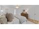 This bedroom features a decorative chandelier, accent rug, and a luxurious bed with a tufted headboard at 6709 Sunhaven Pl, Raleigh, NC 27615