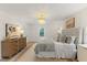 This bedroom features a decorative chandelier, accent rug, and a luxurious bed with a tufted headboard at 6709 Sunhaven Pl, Raleigh, NC 27615