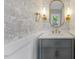 Stylish powder room with patterned wallpaper, gold fixtures, and a gray vanity at 6709 Sunhaven Pl, Raleigh, NC 27615