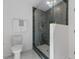 This is a tiled shower with glass enclosure and brass fixtures at 6709 Sunhaven Pl, Raleigh, NC 27615
