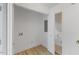 Utility room has white walls, wood floors, and a door leading to another room at 6709 Sunhaven Pl, Raleigh, NC 27615