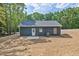 Back of house with blue siding, showcasing backyard, landscaping, and patio at 679 Jasmine Rd, Fuquay Varina, NC 27526