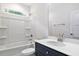Bright bathroom features a shower-tub combo and a navy blue vanity with a white countertop at 679 Jasmine Rd, Fuquay Varina, NC 27526