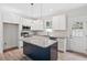 Modern kitchen showcasing white cabinetry, stainless steel appliances, and a granite-topped island at 679 Jasmine Rd, Fuquay Varina, NC 27526