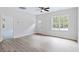 Spacious living room with light flooring, a large window, and a doorway to another room at 679 Jasmine Rd, Fuquay Varina, NC 27526
